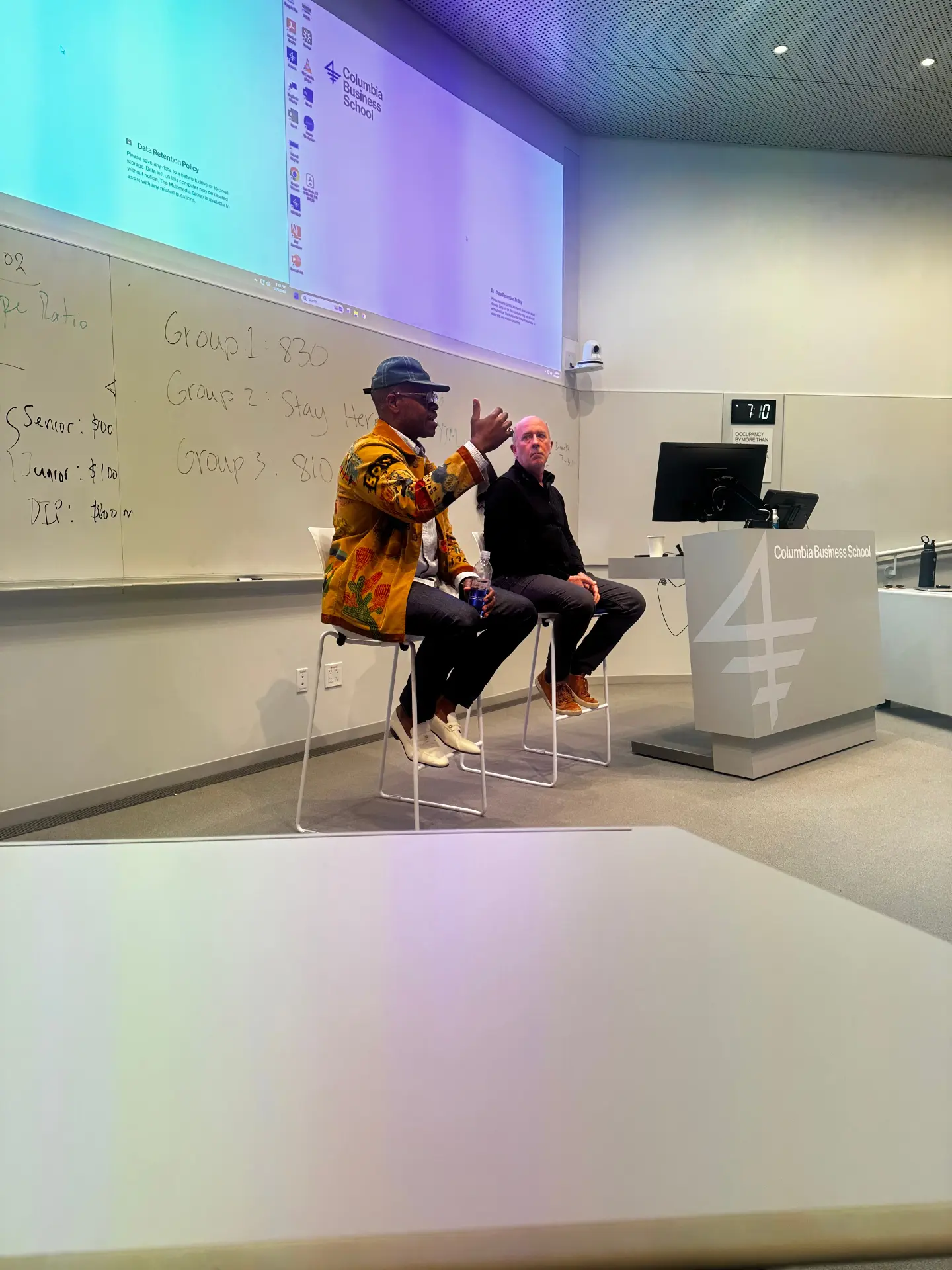 Jamian C. Polk guest lecturing on stage at Columbia Business School